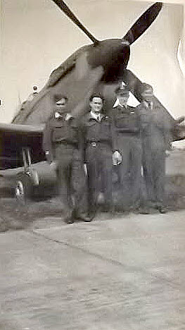 Pilots under nose of No.322 Squadron Spitfire 