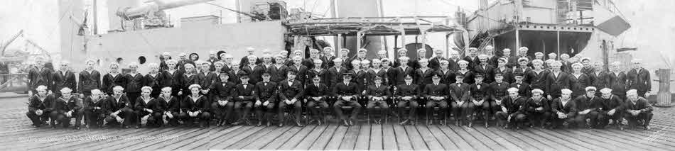 Crew of USS Delphy (DD-261) besides their ship 
