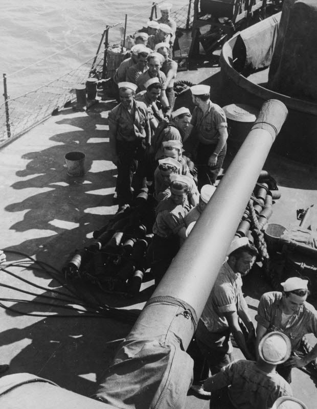 Heaving on a rope while docking USS Stevens (DD-479), 1943 