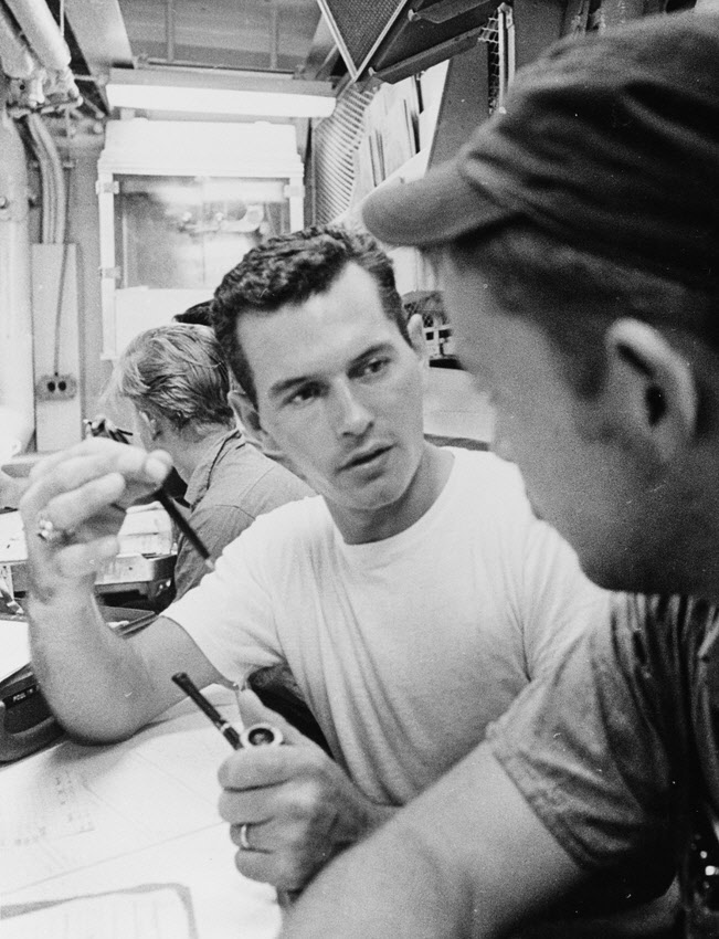 Crew discussing navigation problem on USS John W Thomason (DD-760) , August 1969 