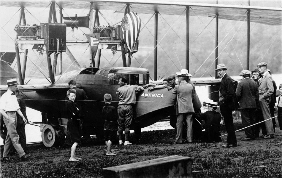 J C Porte in front of Curtiss H-1 America 