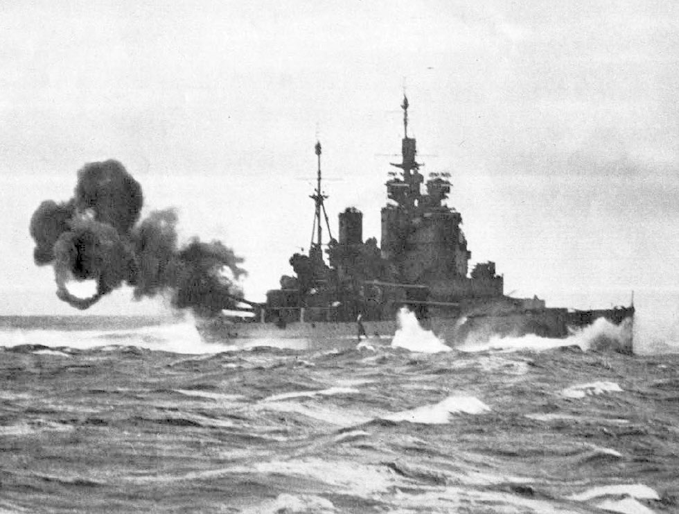 HMS Duke of York firing her main guns 