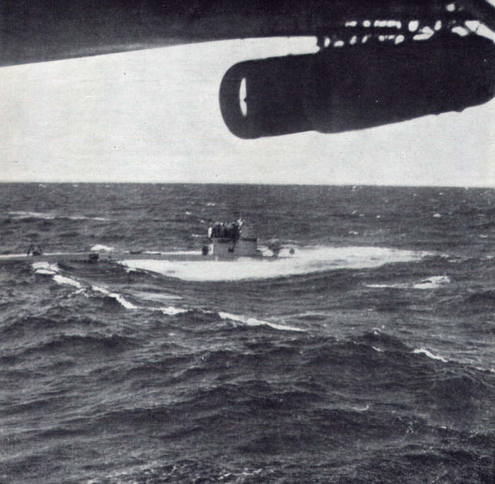 A surfaced U-boat surrendering to a Lockheed Hudson