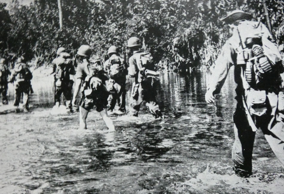 Merrill's Marauders wading along a stream 
