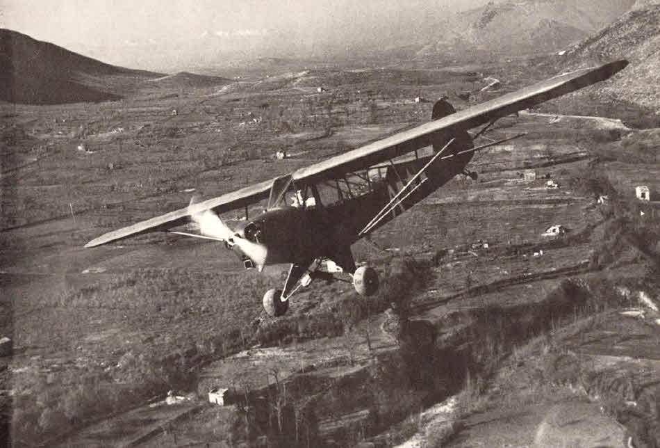 Piper L-4 Grasshopper over scenic valley 