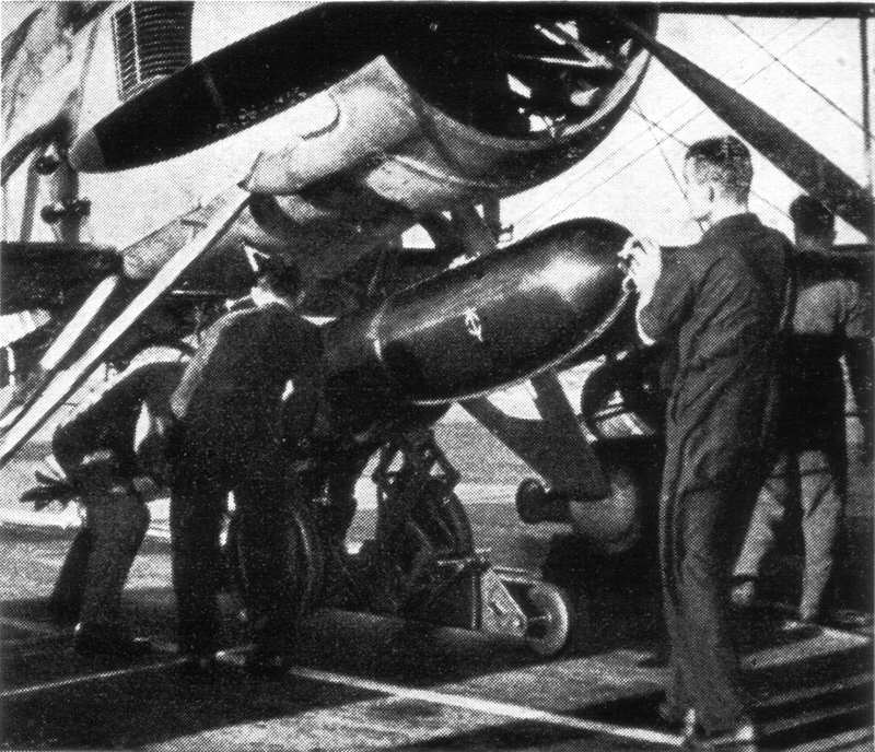 Torpedo being loaded under aircraft 