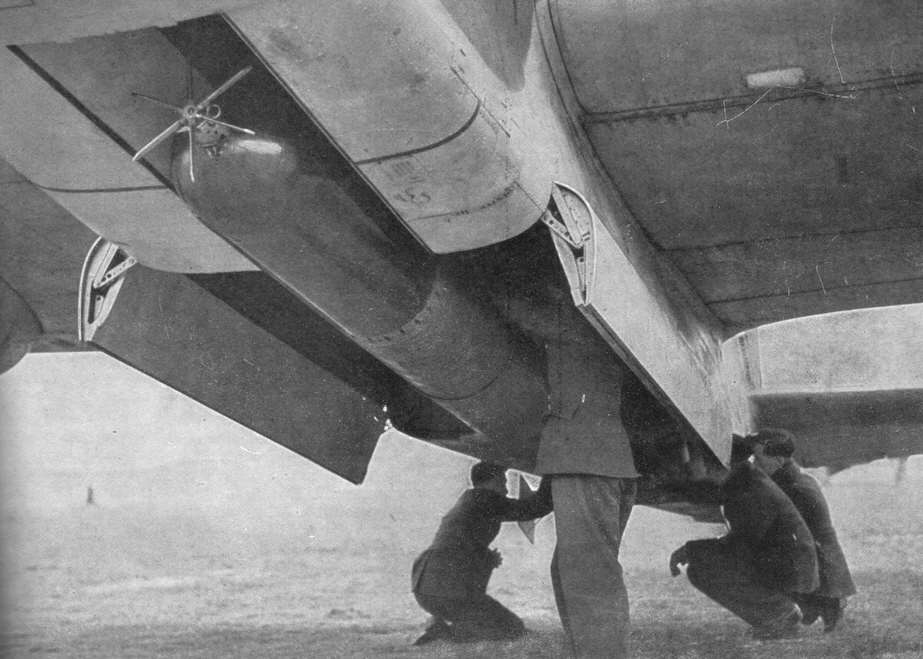 Torpedo being loading into aircraft bomb bay 