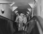 Fighter pilots on escalator, USS Intrepid (CV-11), 1956 