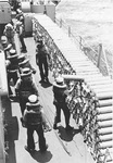 Crew of USS Richard B Anderson (DD-786) unstacking 5in powder cases 
