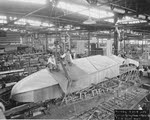 Workers sitting on boat hull of Curtiss F-5L 