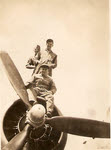 Ground Crew standing on engine of B-17 Flying Fortress 