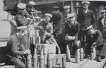 Gunners on HMS Grenville fusing shells 