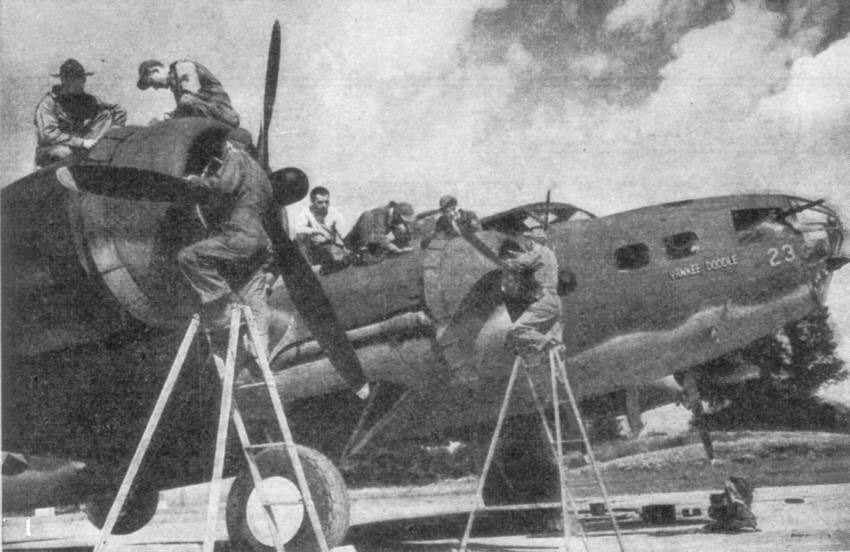 A photograph of a B-17 Flying Fortress "Yankee Doodle" being serviced somewhere in England. 