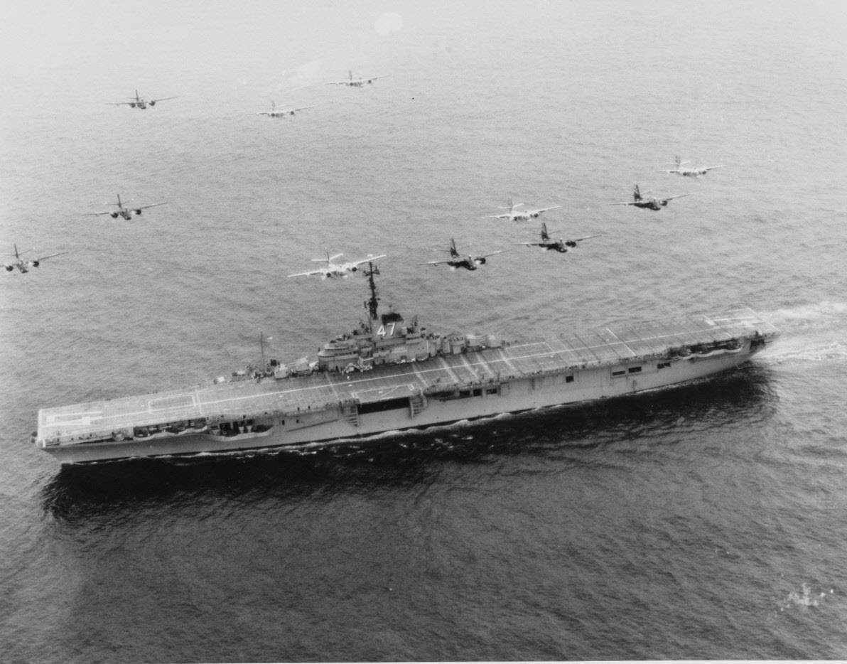 Grumman S2Fs fly over USS Philippine Sea (CV-47) 