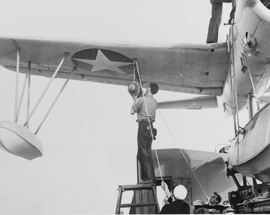 Loading bomb onto OS2U Kingfisher on USS Stevens (DD-479) 