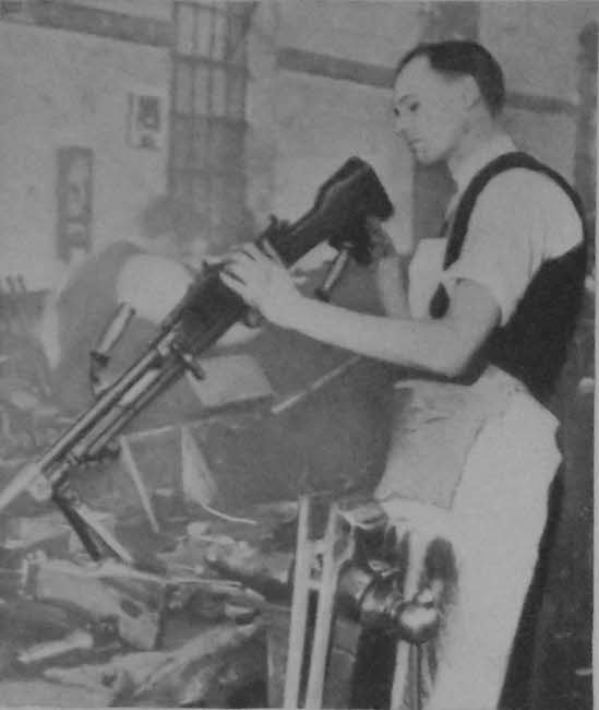 Checking the barrel of a Bren Gun 