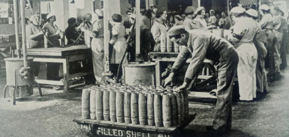 Here we see 25-pounder shells being 'cleaned up' after they have been filled with explosives but before theCleaning up 25-pounder shell after filling 
