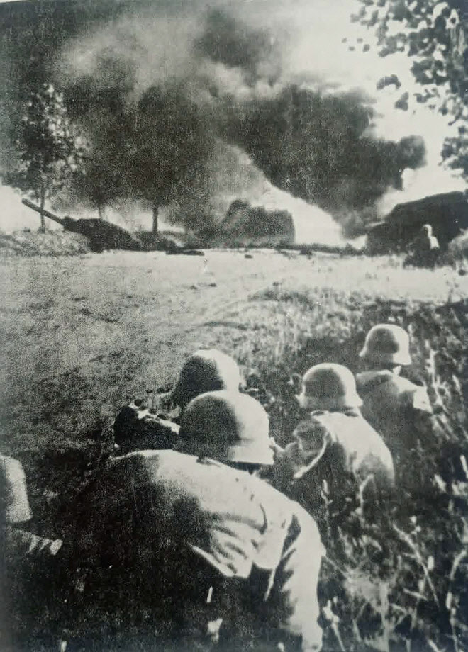 German troops watch burning Soviet Tank 