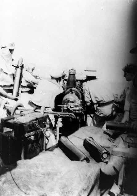 Firing a 12-pounder gun, HMAS Huon 