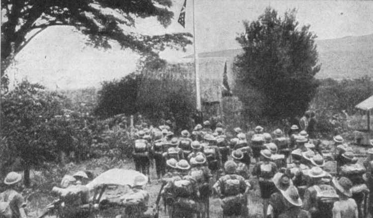 The Australian flag being raised over Kokoda after its liberation on 2 November 1942.