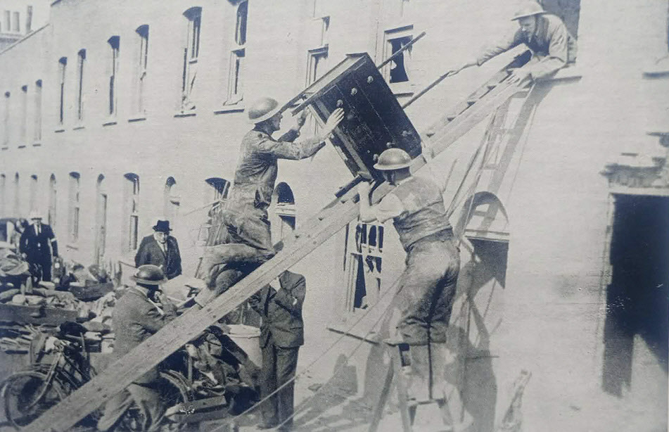 Removing furniture from bomb damaged house, London 