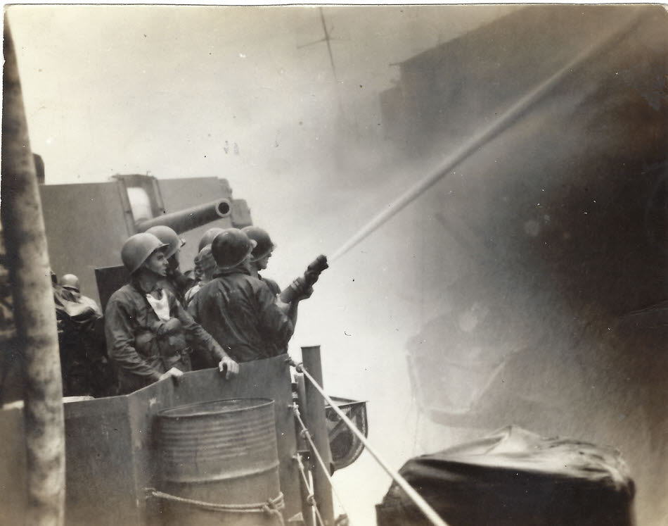 USS Wilkes Barre (CL-103) fighting fires on Bunker Hill (CV-17)